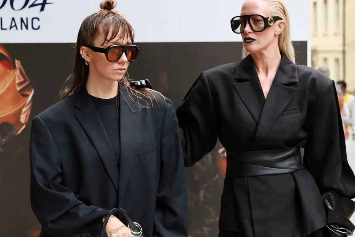 PATINA co-founders Leanne Elliott-Young and Cat Taylor photographed in black outside a campaign billboard